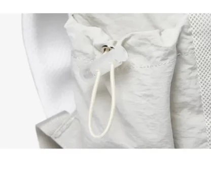 Close-up of the drawstring cord and toggle on the side of the backpack