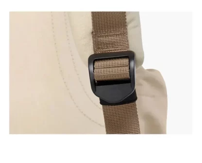 Close-up of an adjustable strap buckle on the beige backpack