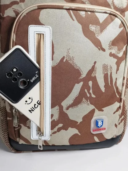Phone slipped into the front pocket of the desert camouflage backpack