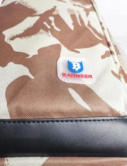 Close-up of the logo patch on the desert camouflage backpack
