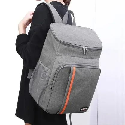 Woman wearing the grey cooler backpack on both shoulders