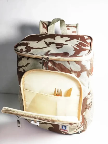 Desert camouflage backpack with the front pocket open, holding cutlery