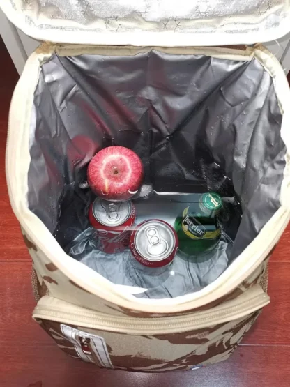 Open desert camouflage backpack showing the insulated lining, drinks and fruit