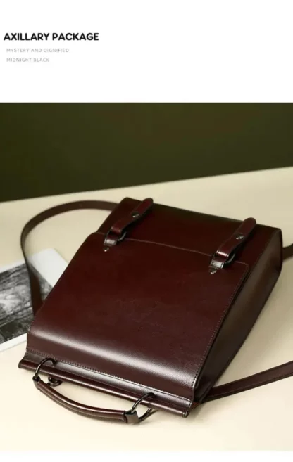 Vintage split leather backpack lying on a table, with the text Axillary package