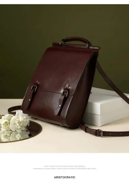 Vintage split leather backpack standing on a table against a green wall