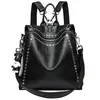 Black women's leather backpack with metal rivets, front view with its top handle and strap