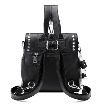 Back of the black riveted leather backpack, with the straps and a back zipper pocket
