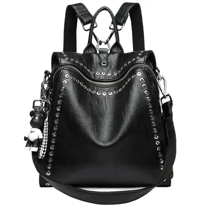 Black women's leather backpack with metal rivets, front view with its top handle and strap