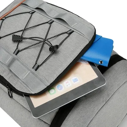 Close-up of a tablet slipped into the front pocket of the light grey backpack