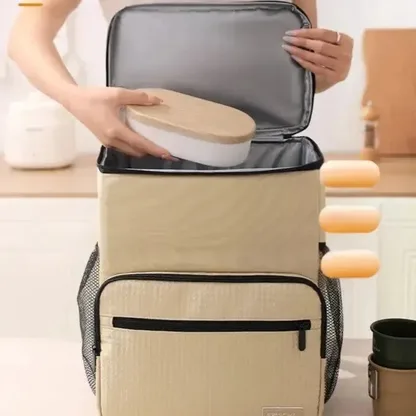 Hand placing a lunch box into the open insulated compartment