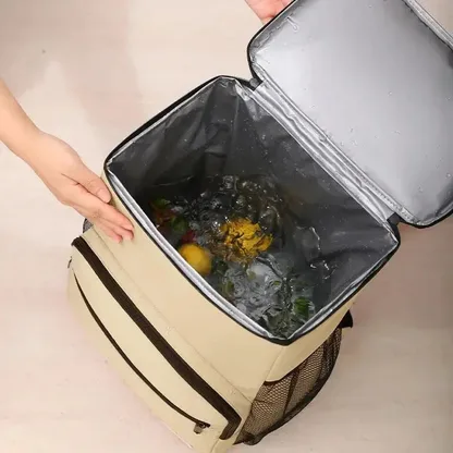 Hand opening the insulated main compartment, filled with ice and fruit
