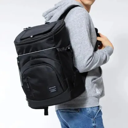 Man carrying the black insulated backpack on one shoulder