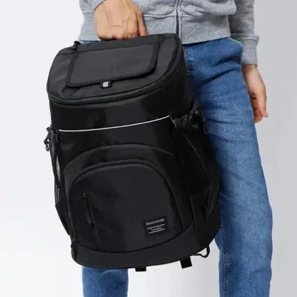 Man holding the black insulated backpack by its top handle