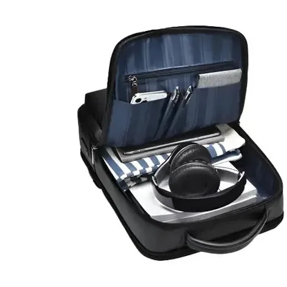 Faux leather laptop backpack opened flat and packed with belongings