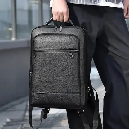 Man carrying the black faux leather laptop backpack by its top handle