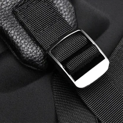 Close-up of a strap buckle on the faux leather laptop backpack
