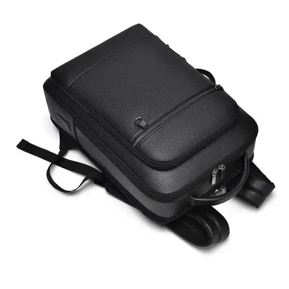 Black faux leather laptop backpack lying flat