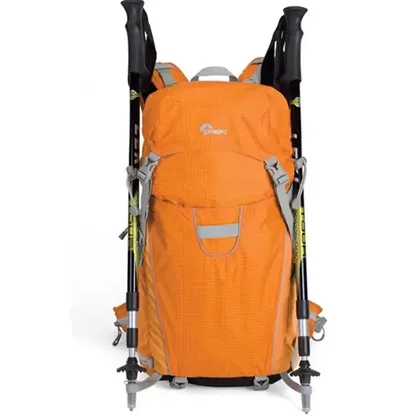Orange backpack with two trekking poles attached to the front